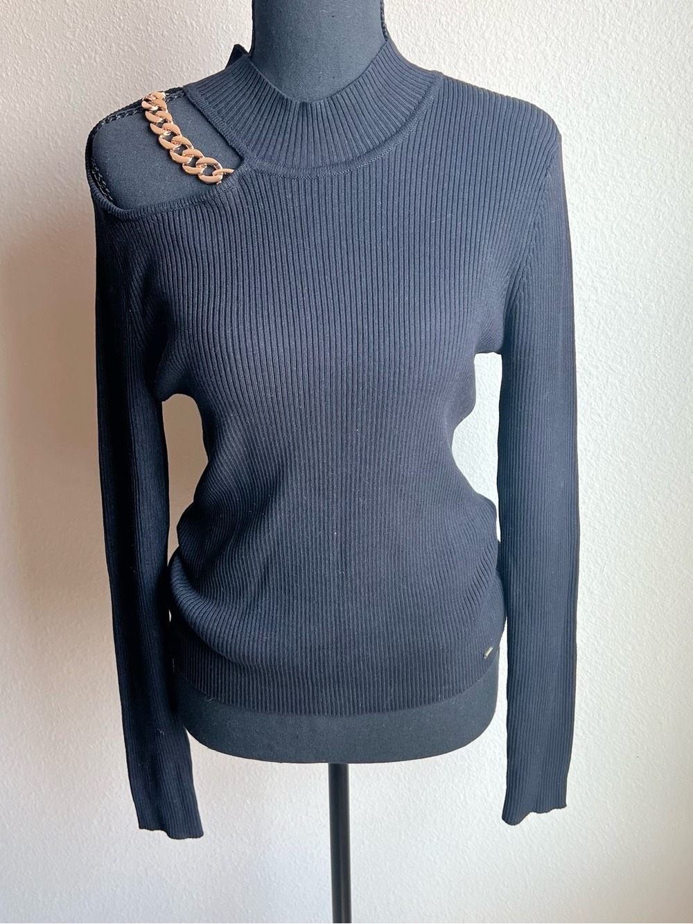 Guess black ribbed mock neck sweater, shoulder, cut out gold chain accent.